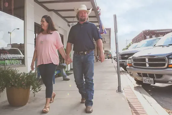 A couple walking down a cute downtown shopping mall.